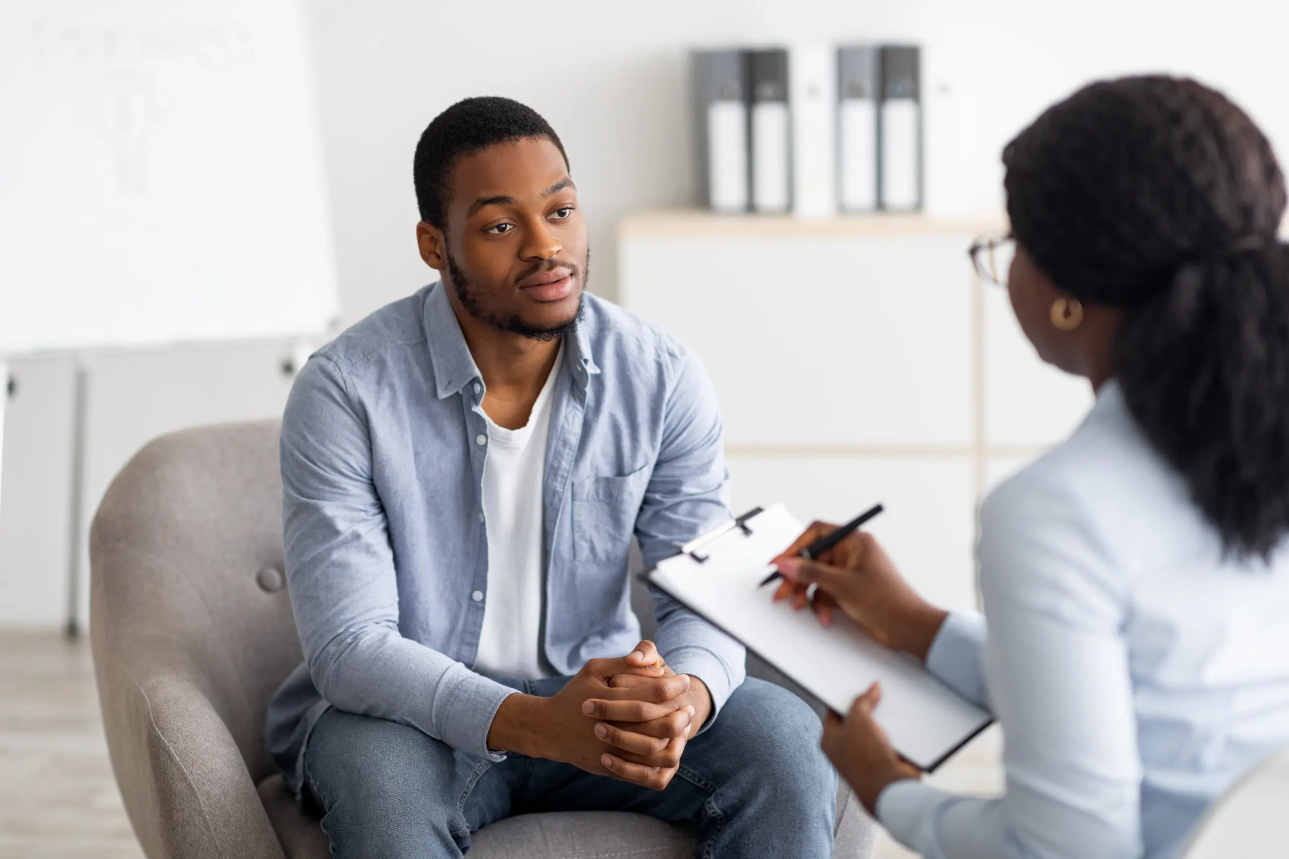 Therapist and patient with worksheet behavioral addiction skills therapy